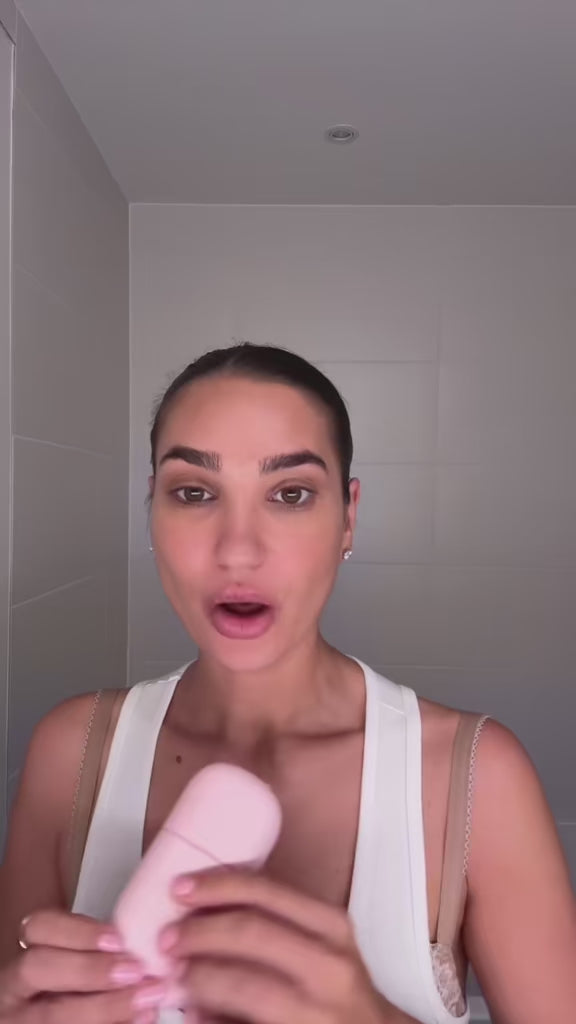 Woman using Glowhaus Sculpt Bar on jawline – ice facial tool